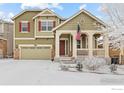 Charming two-story home featuring a welcoming front porch and attached two-car garage at 22898 E Saratoga Pl, Aurora, CO 80015