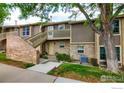 Charming townhome exterior features brick accents, private entrance, and well-maintained landscaping at 2660 E Otero Pl # 7, Centennial, CO 80122