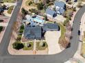 Overhead view of a house with a manicured lawn, pool, and extended driveway in a tranquil neighborhood setting at 3560 Cottonwood Cir, Frederick, CO 80504