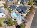Aerial shot showcasing a private backyard oasis complete with a pool, tiki bar, hot tub, and a spacious deck at 3560 Cottonwood Cir, Frederick, CO 80504