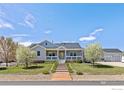 Charming single-Gathering home with a welcoming front porch, professional landscaping, and an attached three-car garage at 3560 Cottonwood Cir, Frederick, CO 80504