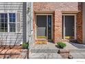 Charming front entrance with brick accents, a decorative welcome mat, and well-maintained landscaping at 406 N Parkside Dr # C, Longmont, CO 80501