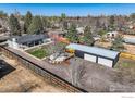 Expansive backyard with a multi-car garage, mature trees, and ample parking at 7750 W 9Th Ave, Lakewood, CO 80214