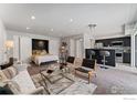 Open floor plan showcasing living area with modern decor, kitchen bar, and comfortable furnishings at 9680 Brentwood Way # 203, Broomfield, CO 80021