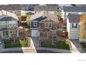 Aerial view of cozy home nestled among neighboring houses with a well kept lawn and inviting curb appeal at 10591 Forester Pl, Longmont, CO 80504
