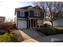 Inviting two-story home with a one car garage, complimented by a well-maintained lawn and mature tree at 10591 Forester Pl, Longmont, CO 80504