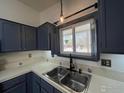 Charming kitchen with dual stainless steel sink and a bright window view to the outdoors at 1406 Oak Dr, Berthoud, CO 80513