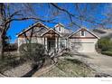 Attractive home featuring varied roof lines, dormer windows, and mature landscaping at 1430 Bluefield Ave, Longmont, CO 80504