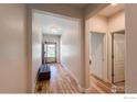 Bright foyer with hardwood floors, a cozy bench, and a view of the front door at 1512 Lasalle Way, Longmont, CO 80504