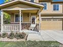 Welcoming front porch featuring classic columns, stone accents, and space for outdoor seating at 1512 Lasalle Way, Longmont, CO 80504