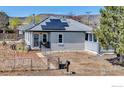 Charming home featuring solar panels, xeriscaping, mountain views, and a fenced front yard at 15205 W 43Rd Ave, Golden, CO 80403