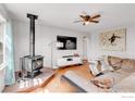 Inviting living room featuring hardwood floors, fireplace, and lots of natural light at 15205 W 43Rd Ave, Golden, CO 80403