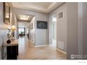 Welcoming foyer with light hardwood flooring and an inviting decor at 16024 Columbine St, Thornton, CO 80602