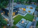Beautiful backyard showcasing a modern patio area with a fire pit, lush lawn, and a deck perfect for entertaining at 1670 Linden Ave, Boulder, CO 80304