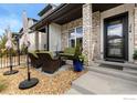 Inviting front porch with stone pillars and outdoor seating, perfect for relaxing at 174 High Point Dr, Longmont, CO 80504