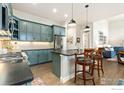 Stylish kitchen featuring shaker cabinets, stainless steel appliances, and center island with seating at 174 High Point Dr, Longmont, CO 80504