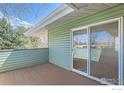 View of the private balcony, with sliding glass doors and wood-look flooring at 1805 Chalcis Dr # E, Lafayette, CO 80026