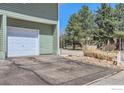 Image shows single car garage with driveway at 1805 Chalcis Dr # E, Lafayette, CO 80026