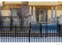 Street view of property showing front fence, entryway, stone facade and landscaping at 1950 N Logan St # 102, Denver, CO 80203