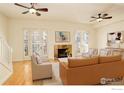Bright living room featuring a fireplace, wood floors, and french doors at 1950 N Logan St # 102, Denver, CO 80203