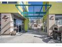 A covered walkway between buildings, featuring a unique architectural design and outdoor seating at 2018 Ionosphere St # 6, Longmont, CO 80504