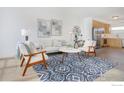 Bright living area with modern decor, comfortable seating, and an open-concept kitchen at 2018 Ionosphere St # 6, Longmont, CO 80504