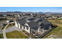Aerial view of the house with large roof, gray siding, and manicured front lawn at 2774 Heron Lakes Pkwy, Berthoud, CO 80513