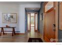 Inviting entryway featuring hardwood floors, stylish decor, and a seamlessly integrated design at 3080 7Th St, Boulder, CO 80304