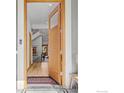 The front door opens to reveal an entryway with light hardwood floors and views of the staircase at 3080 7Th St, Boulder, CO 80304