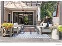Inviting covered patio with stylish seating, a patterned rug, and access through sliding glass doors at 3080 7Th St, Boulder, CO 80304