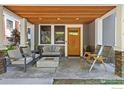 Inviting covered porch with comfortable seating, a fire pit, and wood ceiling, ideal for enjoying the outdoors at 3080 7Th St, Boulder, CO 80304