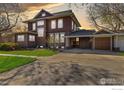 A spacious home featuring a large driveway leading to a convenient covered parking area at 329 Bross St, Longmont, CO 80501