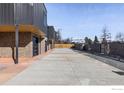 Long driveway leading to modern townhomes with gray metal and brick exteriors at 3309 Broadway Ave, Boulder, CO 80304