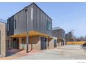 Attractive townhomes with gray metal and brick exteriors, individual garages, and modern design at 3309 Broadway Ave, Boulder, CO 80304