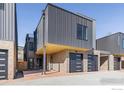Contemporary townhomes featuring a metal exterior, private garages, and covered parking at 3309 Broadway Ave, Boulder, CO 80304