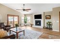 Bright living room with fireplace, ceiling fan and lots of natural light at 3401 Mountain View Ave, Longmont, CO 80503