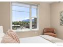 This bedroom features a large window overlooking a beautiful mountain view and has neutral colored walls at 3601 Arapahoe Ave # 422, Boulder, CO 80303