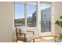 Living room with lots of natural light, hardwood floors, and access to the outdoor balcony at 3601 Arapahoe Ave # 422, Boulder, CO 80303