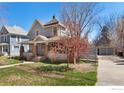 Charming home with a covered front porch, mature trees, and a detached garage, creating a serene setting at 436 Pratt St, Longmont, CO 80501