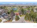 A scenic aerial view shows the home, golf course, and Rocky Mountain backdrop at 4749 Old Post Ct, Boulder, CO 80301