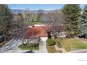 A home shows a red roof, mature landscaping, and a long private driveway at 4749 Old Post Ct, Boulder, CO 80301