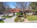 A front exterior view of a house with a charming landscape design, two-car garage and red roof at 4749 Old Post Ct, Boulder, CO 80301