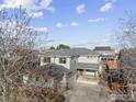 An aerial view showing the home with well-maintained landscaping and a large driveway in a residential area at 5209 Royal Pine St, Brighton, CO 80601