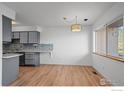 Bright dining area adjacent to kitchen features modern lighting and hardwood floors at 546 Ridgeview Dr, Louisville, CO 80027