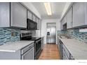 Modern kitchen features stainless steel appliances, sleek countertops, and stylish backsplash at 546 Ridgeview Dr, Louisville, CO 80027