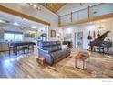 Open concept living area with vaulted ceilings, wood beams, seamless flow to the modern kitchen at 6251 County Road 20, Longmont, CO 80504