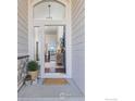Welcoming front doorway that opens to a view of the interior, featuring hardwood floors and modern decor at 675 Lene Ln, Berthoud, CO 80513