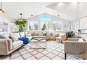 Bright living room featuring vaulted ceilings, large windows, and stylish, comfortable furniture at 803 Ithaca Dr, Boulder, CO 80305