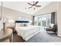 Serene main bedroom with a sliding glass door to a private balcony and seating area at 803 Ithaca Dr, Boulder, CO 80305