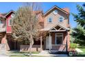 Inviting home featuring a covered front porch, brick accents, and neat landscaping at 835 Kane Dr # 27, Longmont, CO 80501